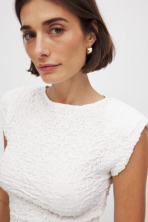 Topp med skarpa axlar