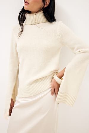 Offwhite Pullover mit Wollstrickärmeln und Schlitz