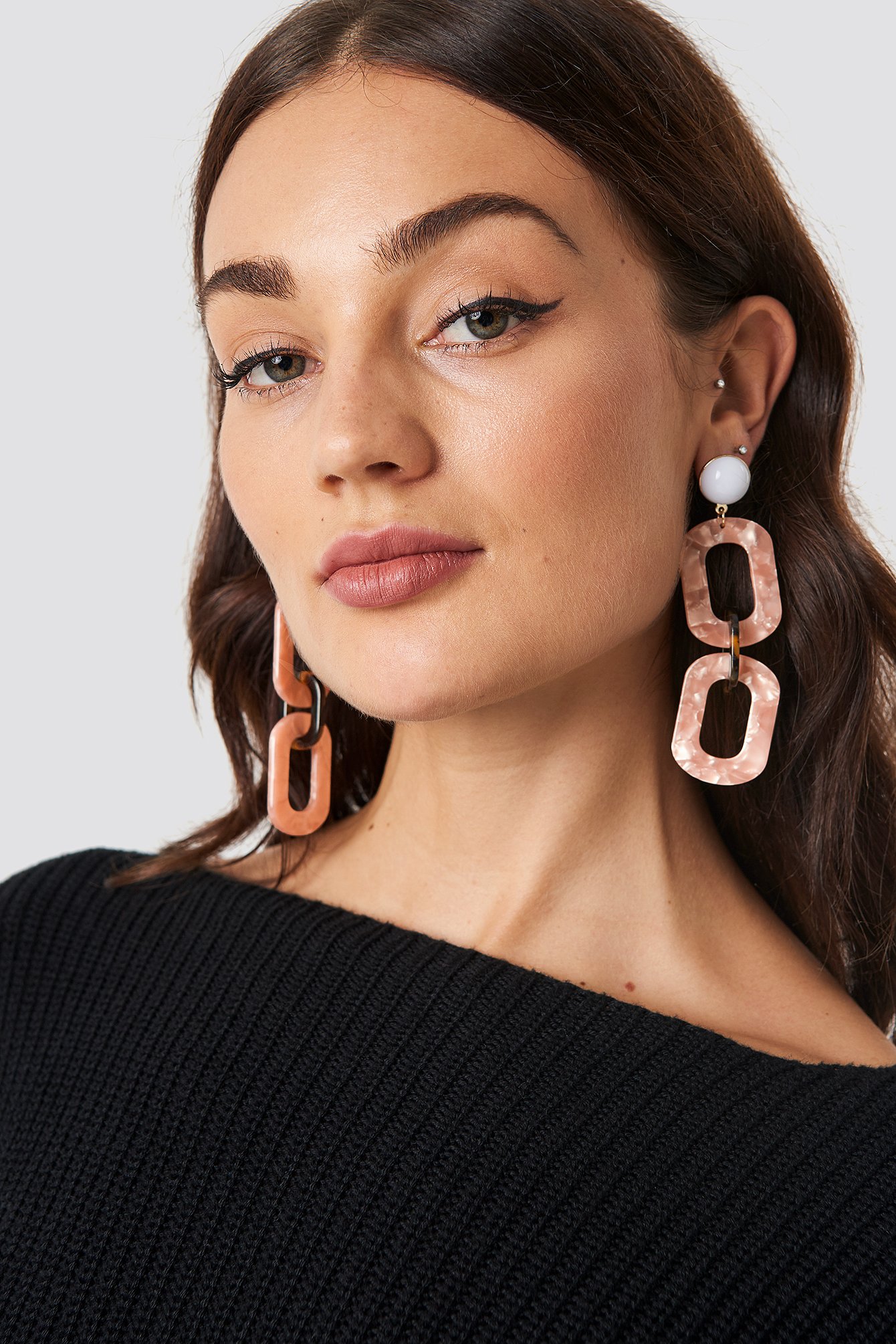 The Chained Resin Look Earrings by NA-KD Accessories features a dangling design with chained resin hoops, and a bullet clutch backing.