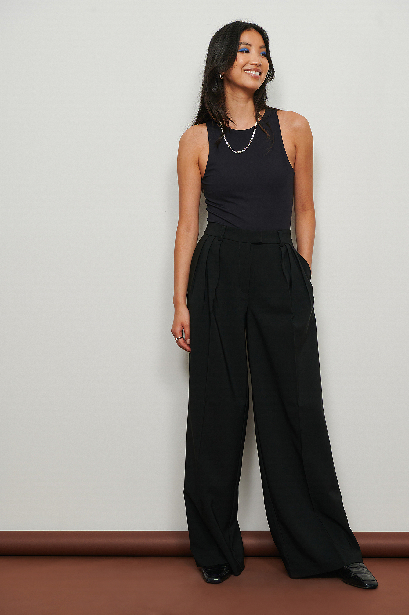 Pantaloni eleganti ampi a vita bassa in tessuto plissettato riciclato Nero  | na-kd.com