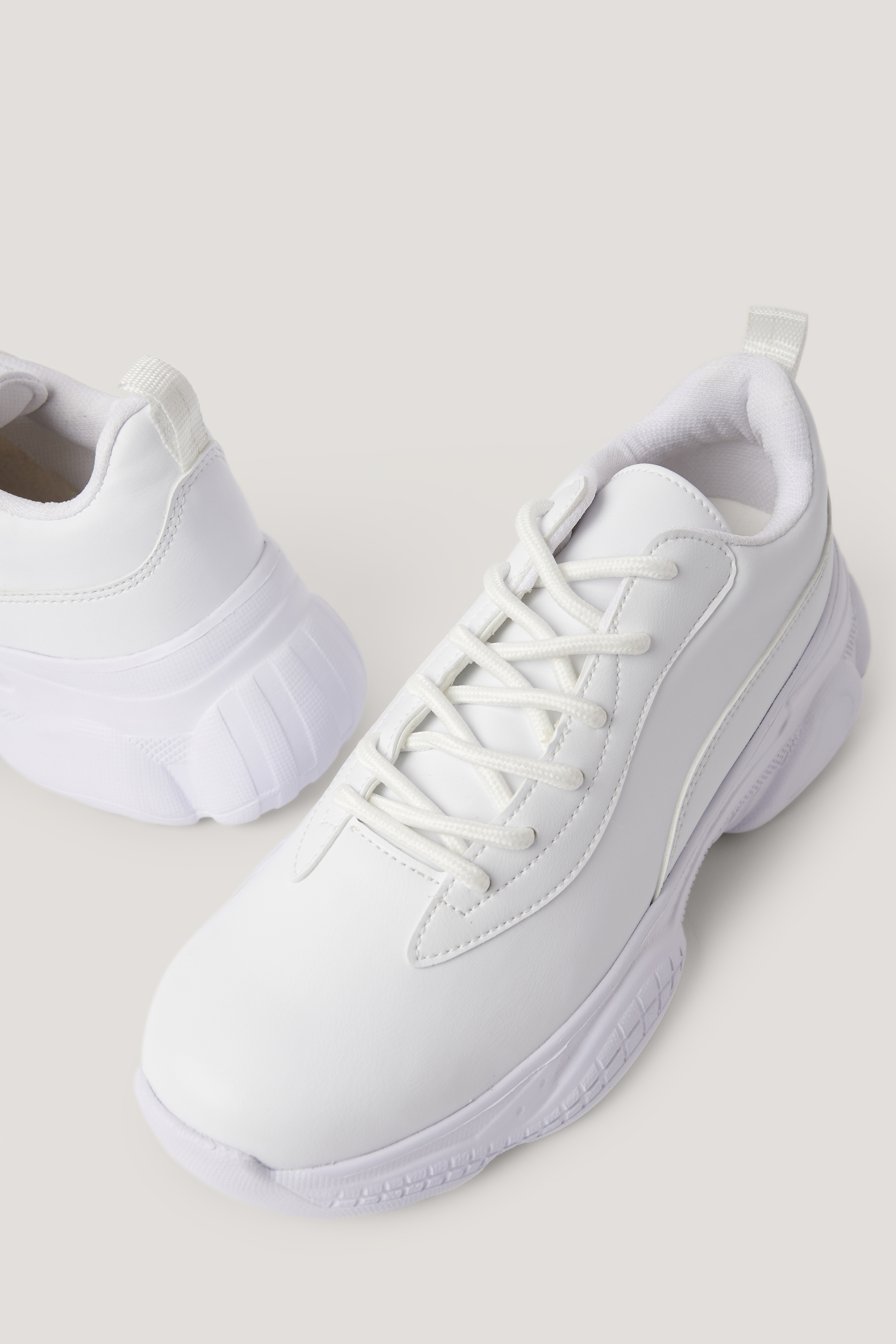 slim white trainers