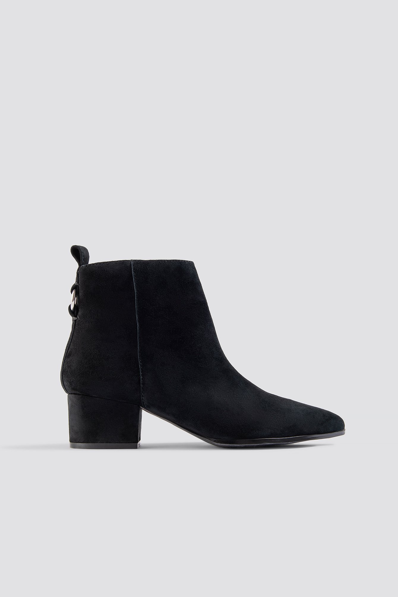 The Clover Ankleboot by Steve Madden features a soft, suede material, a block heel and a pointy toe, a side zipper closure, and a buckle detail in the back.