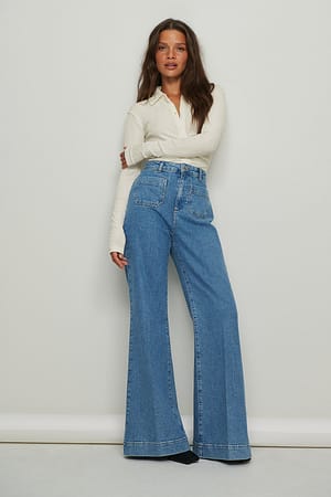 Mid Blue Jeans a gamba ampia con tasche frontali modello anni ‘70