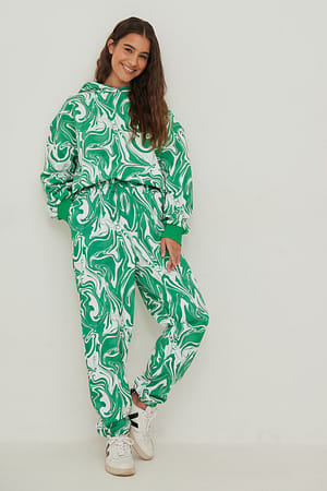 Green Swirl Print Sweatpants med tryck och avsmalnande ben