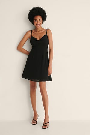 Black Doorzichtige mini-jurk met knoop op de schouder